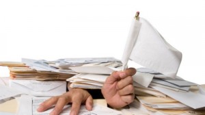 a travel nurse buried under a pile of paperwork