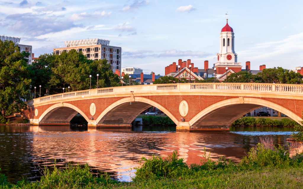 Walk across a picturesque bridge on the Charles River in Boston, and you’ll find yourself near Harvard’s campus.