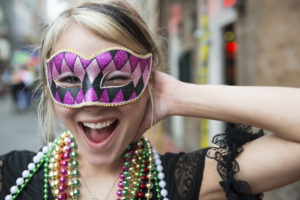Fun-loving young woman at Mardi Gras in New Orleans Louisiana