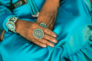 ap of woman wearing traditional blue dress and rings