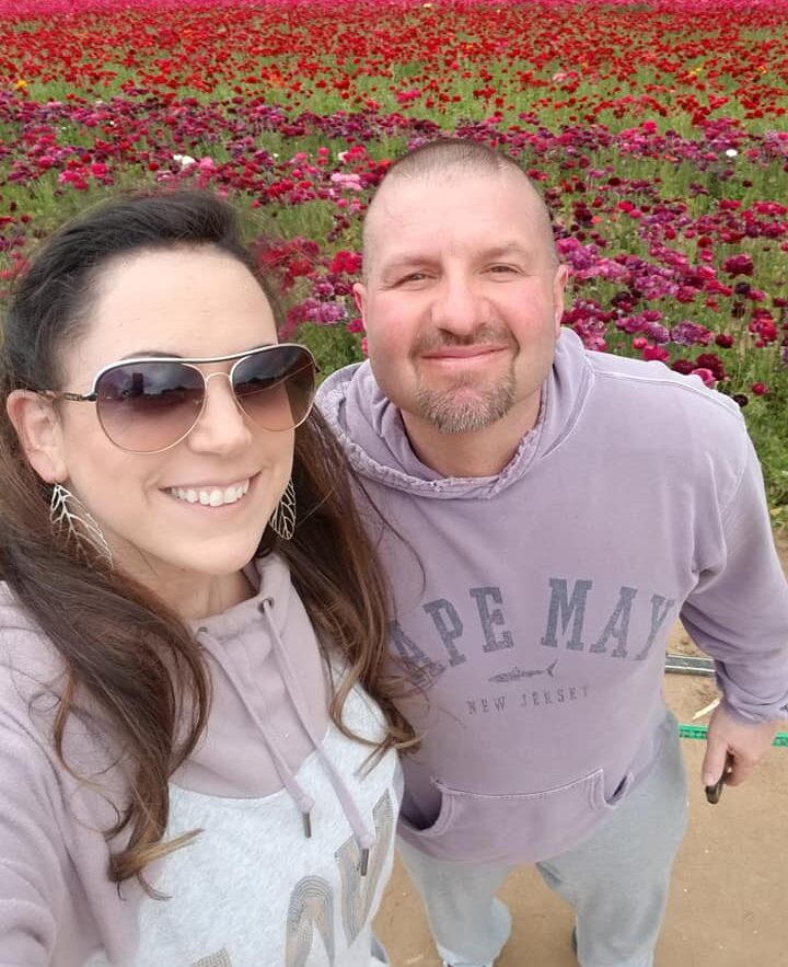 Woman and man standing in front of flower fields