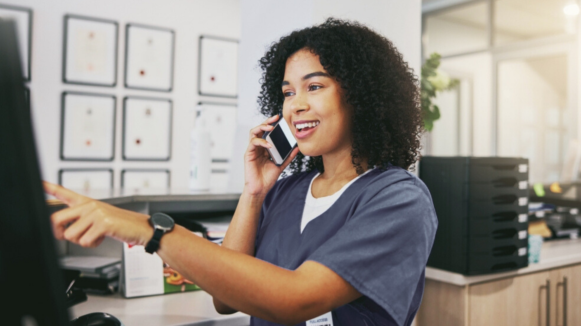 Travel nurse smiling, talking on the phone in work environment