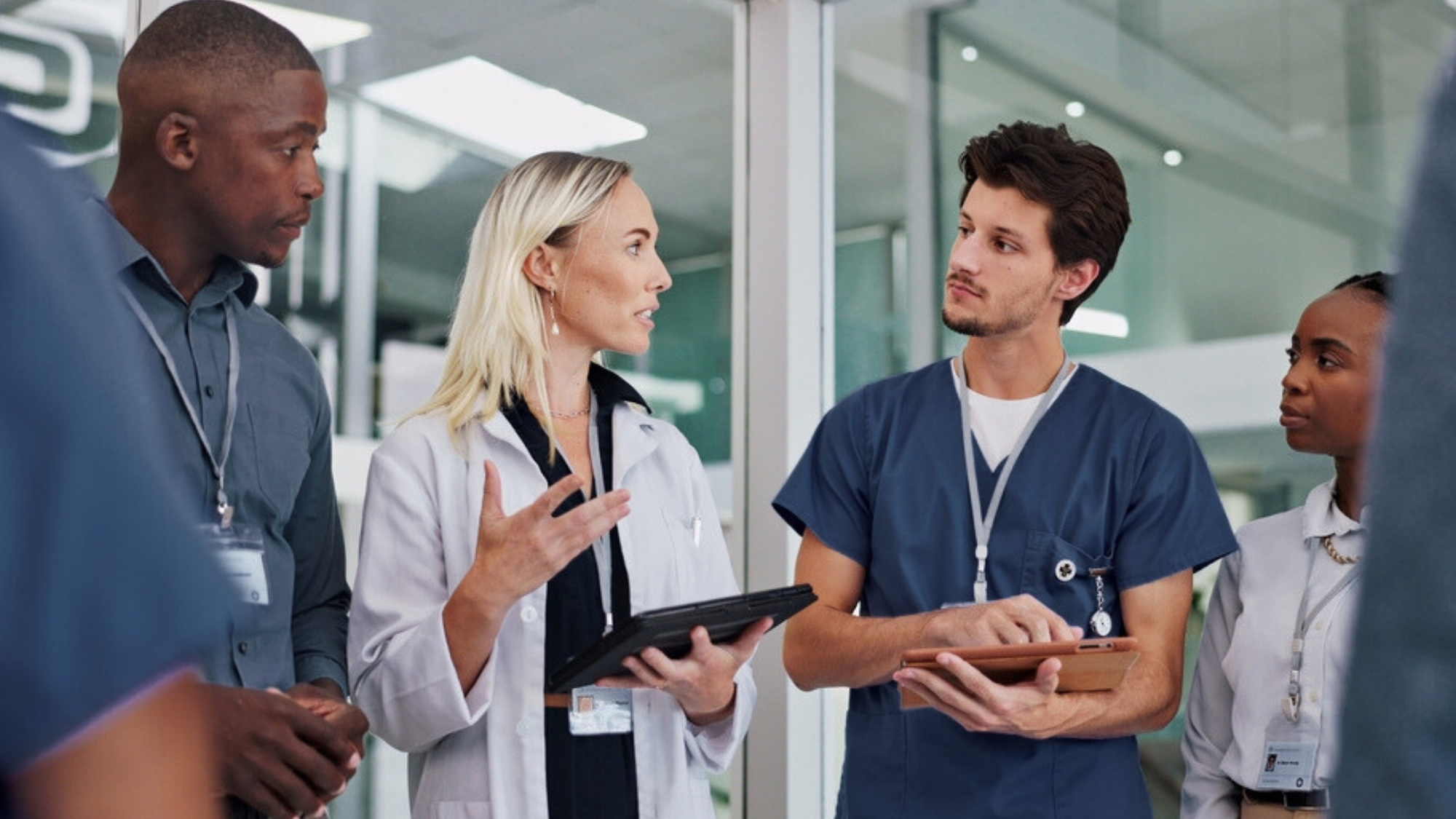 Group of travel nurses discussing treatment with a physician