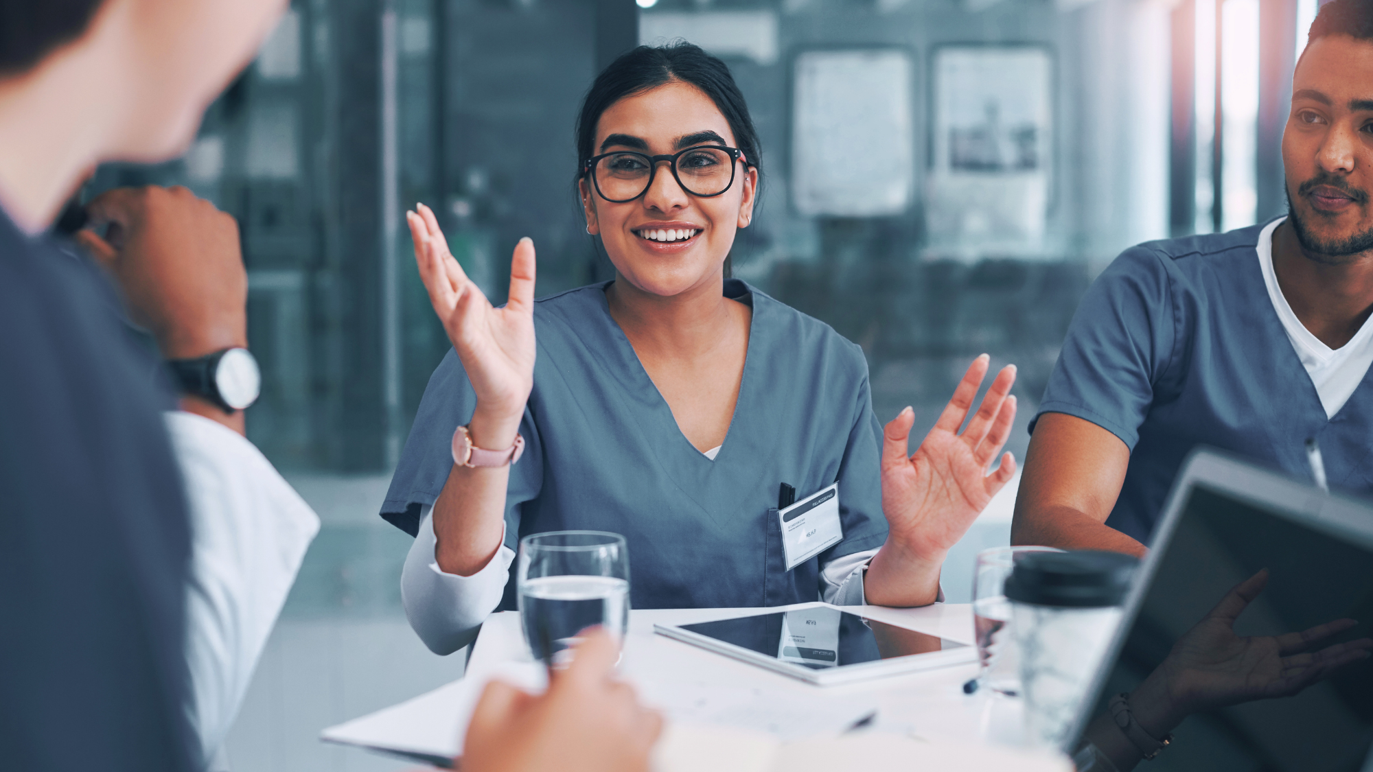 A female nurse talking to a group of people