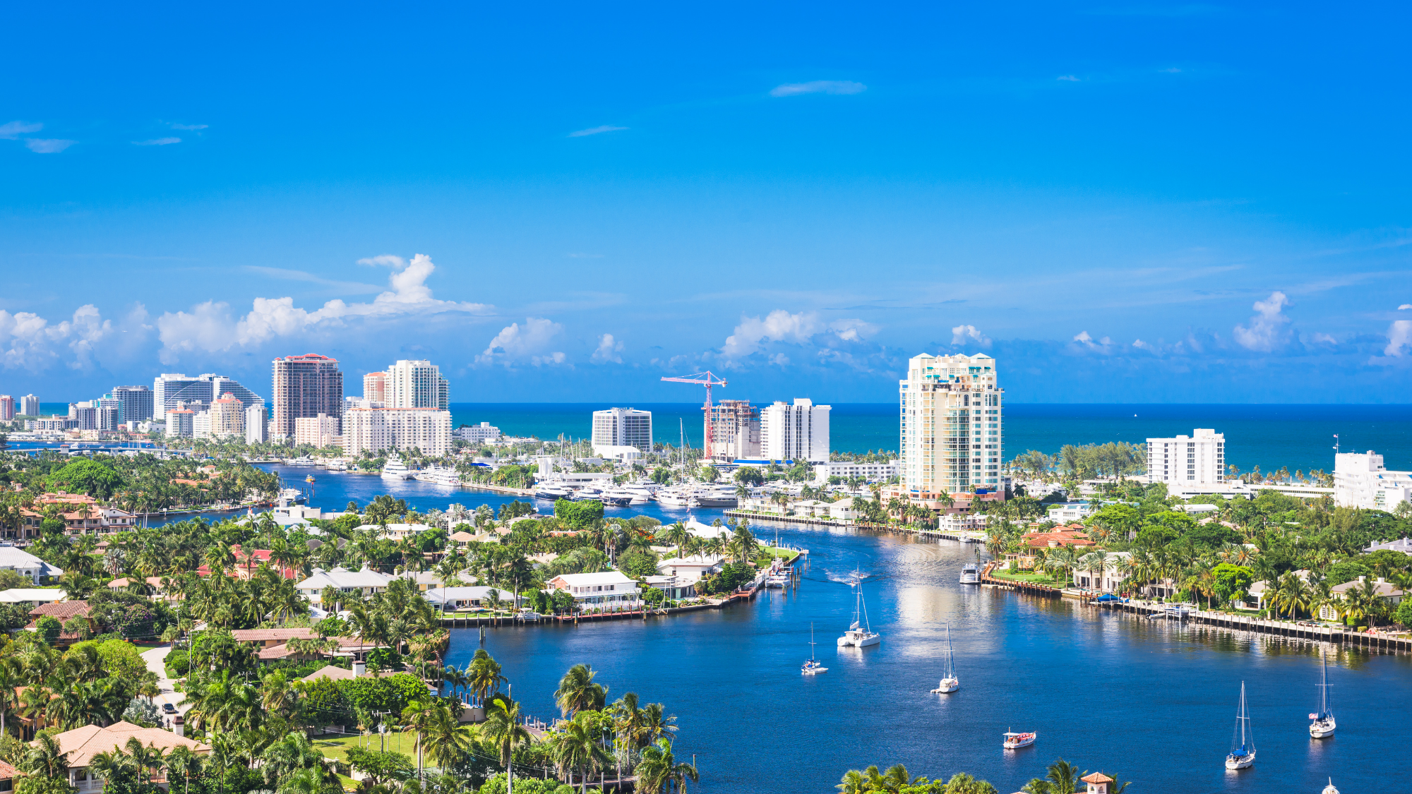 Scenic view of a city next to water during the day time.