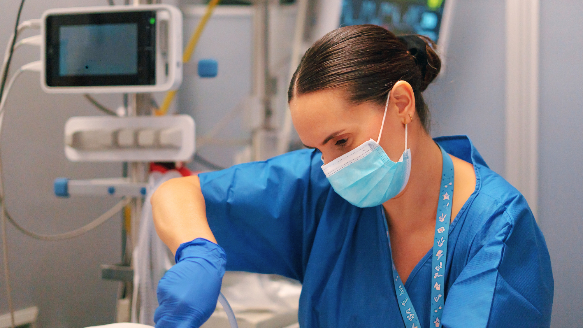Female ICU nurse working on a patient.